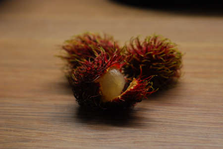Fresh half peeled rambutan fruitの写真素材