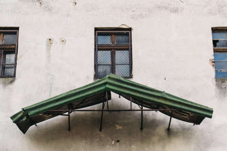 Old house facade with green roof