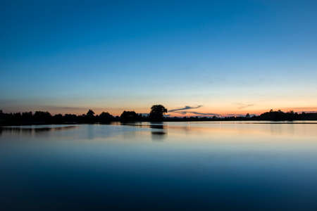 Evening and sunset at the lakeの写真素材