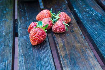 Red strawberries on a wooden tableの写真素材