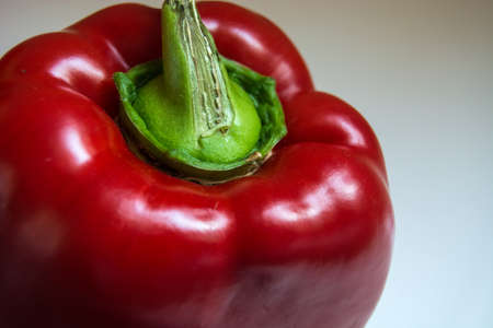 Red big pepper with green tail on the close-up