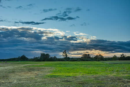 Meadow and clouds after sunset. Nowiny, Polandの写真素材