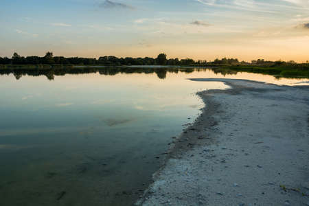 Shore and beach of a calm lake, evening view in Staw, Polandの写真素材