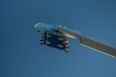 Chelm, Lubelskie, Poland - May 30, 2018: People on the carousel Booster against the blue skyのeditorial素材