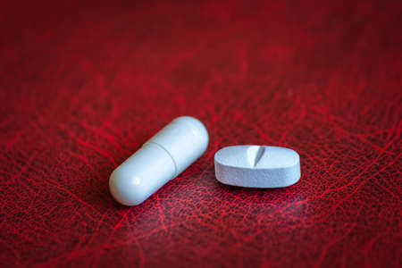 Two medicine pills lies on the table in close-up