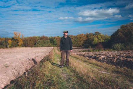 Man on dirt road, view on autumn dayの写真素材