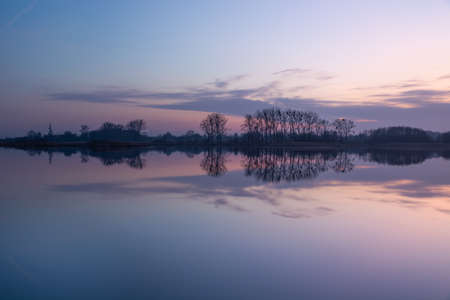 The reflection of evening clouds in calm water, Stankow, Lubelskie, Poland