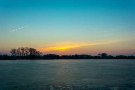 The sky after sunset over the frozen lake, Stankow, Lubelskie, Polandの写真素材