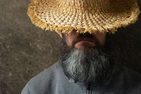 A napping man with a long beard in a hat, male portraitの写真素材