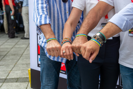 Chelm, Lubelskie, Poland - July 31, 2022: 79 tour de Pologne, Gianni Bugno with Agata Lang, Czeslaw Lang and John Lelangue, show bracelet in the colors of the Ukrainian flagのeditorial素材