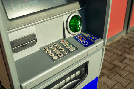 View and close-up of an ATM with a keyboard in English and Polish, eastern Poland