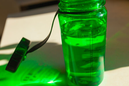 Water in a tritan green bottle on the counter