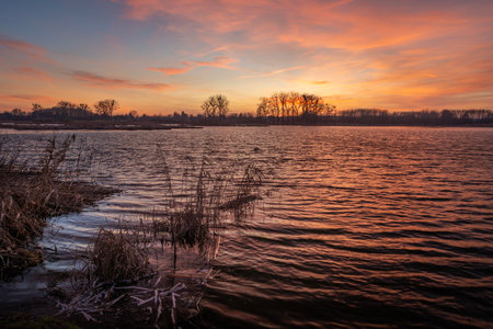 Still Lake and Reeds Under Colorful Evening Sky, Stankow, Eastern Polandの写真素材