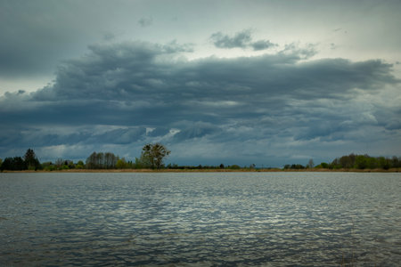 Cloudy gray sky over a lake in eastern Polandの写真素材