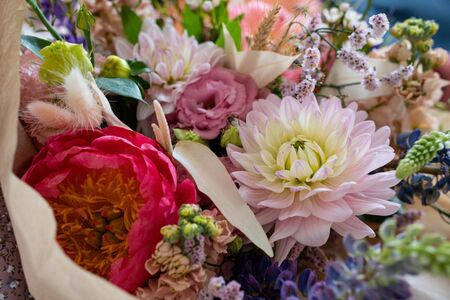 Beautiful bouquet of mixed blossoming fresh flowers. Background of flowers. delicate colorful boho style bouquet of peony, gillyflower, eustoma, clove branch, dill, sea lavender, gerberaの写真素材
