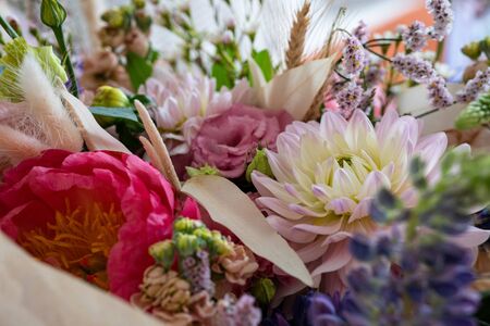 Beautiful bouquet of mixed blossoming fresh flowers. Background of flowers. delicate colorful boho style bouquet of peony, gillyflower, eustoma, clove branch, dill, sea lavender, gerberaの写真素材