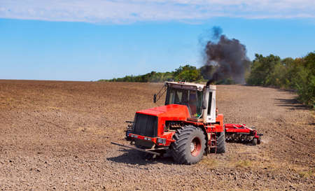 tractor in a field plowing