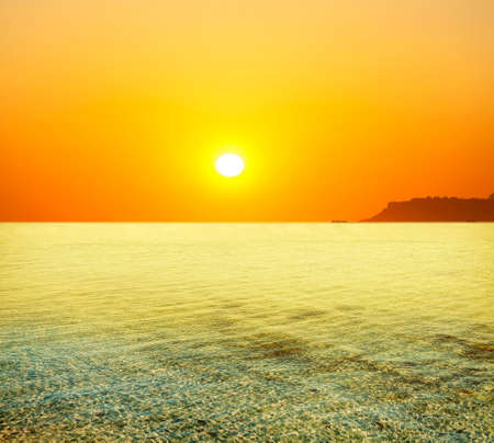 The sea is calm and the sunの写真素材