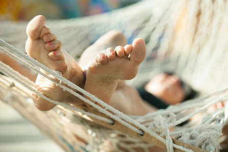 girl in a hammock on the beachの写真素材