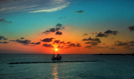 sailboat against a background of picturesque sunsetの写真素材