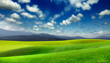 Green meadow and mountains on the horizonの写真素材