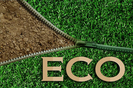 green zipper on green grass texture over brown mulberry paper texture empty blank for fill text background.の写真素材