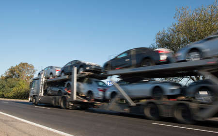 The trailer transports cars on highwayの写真素材