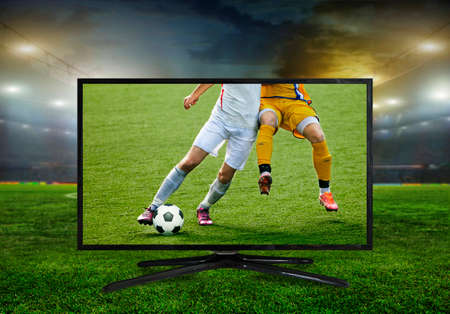 watching smart tv translation of football game.の写真素材