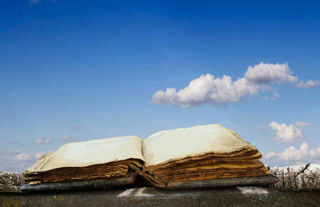 old book on a wooden platform against the skyの写真素材