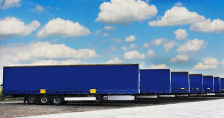 Truck semi trailers waiting to be unloaded at a warehouse or factoryの写真素材