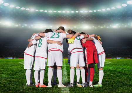 Football team players Hug the neck and for pray before playing football this image present about teamwork conceptの写真素材