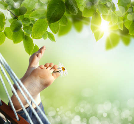 Relax in nature. Feet close up in a hammock