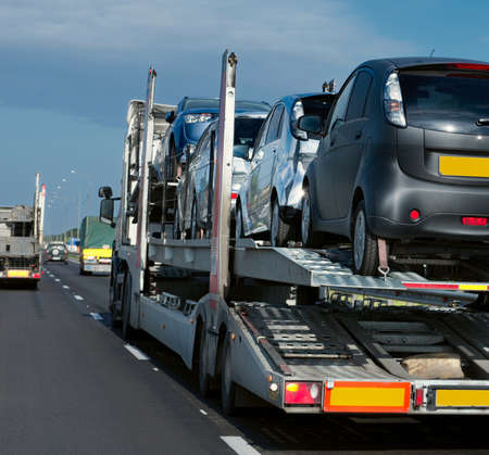 The trailer transports cars on the highwayの写真素材