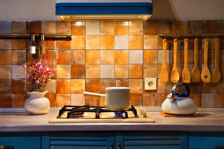 New pan with wooden handle on the stove. On fireの写真素材