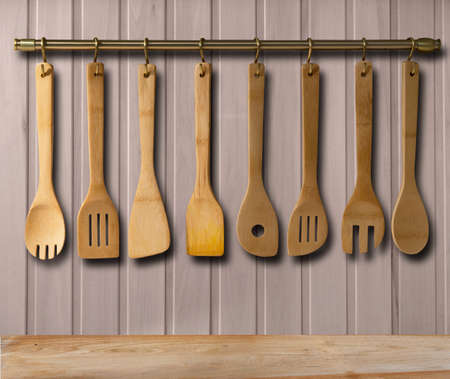 Kitchen brass utensils, chef accessories. Hanging copper kitchen with white tiles wallの写真素材