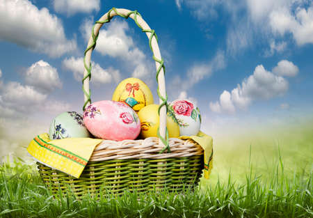 basket with Easter eggs on a green background.