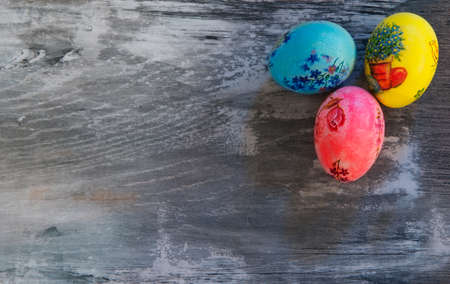 aster eggs, painted, patterned on the old wooden backgroundの写真素材