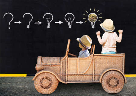 Two little boys are painting with chalk on a school board. Ideas are invented.
