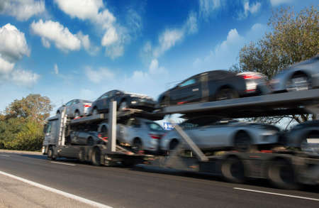 The trailer transports cars on highwayの写真素材