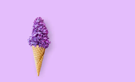 Conceptual and creative idea to combine a lilac bouquet with a glass for ice creamの写真素材