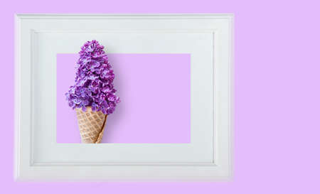 Conceptual and creative idea to combine a lilac bouquet with a glass for ice creamの写真素材