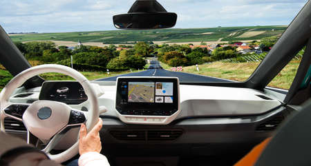 Two women driving a car travel on the roads of Europe