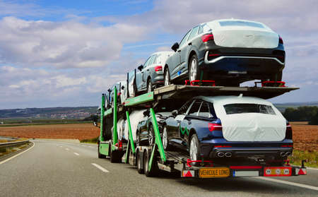 The trailer is engaged in the delivery of new cars to their place of salesの写真素材