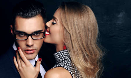 fashion studio photo of beautiful sensual impassioned couple. office love storyの写真素材