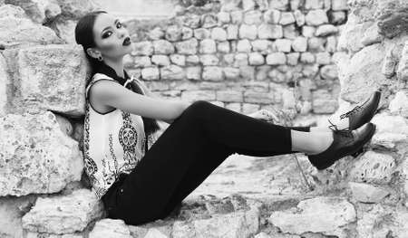 Fashion black and white outdoor photo of sexy elegant woman with dark hair wearing elegant...