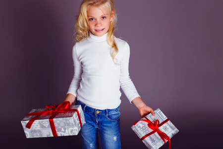 holiday photo of cute little girl with Christmas presents
