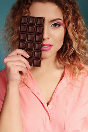 fashion photo of beautiful woman with dark hair with chocolate