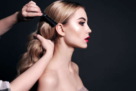 fashion studio portrait of gorgeous young woman with blond hair, making make upの写真素材