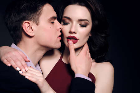 Valentine's day. fashion studio photo of lovely impassioned couple in elegant outfitの写真素材