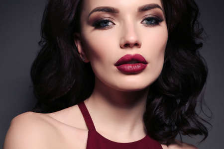 fashion studio photo of gorgeous sexy woman with dark hair in elegant dress